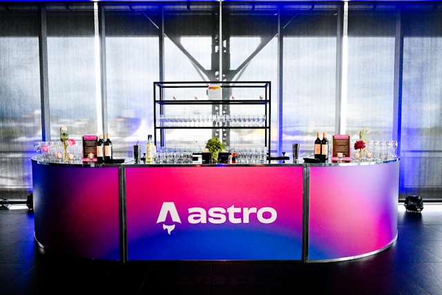 Vibrant blue and red alcohol bar with the Astro logo across it in white.