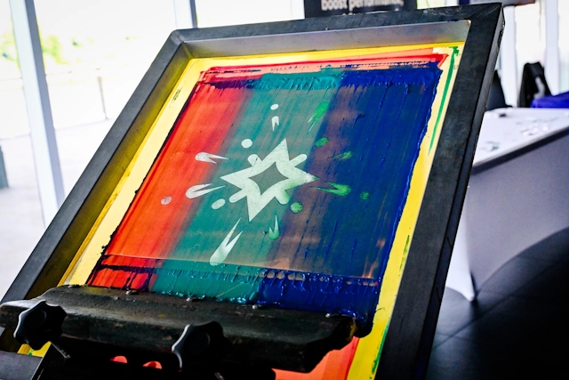 T-shirt printing press with the Starlight logo design.