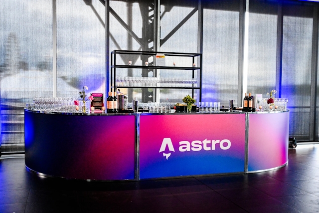 Vibrant blue and red alcohol bar with the Astro logo across it in white.