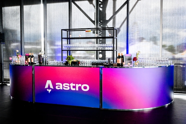 Vibrant blue and red alcohol bar with the Astro logo across it in white.