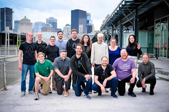 The Astro core team poses outside the meetup venue with the Montreal skyline behind them.