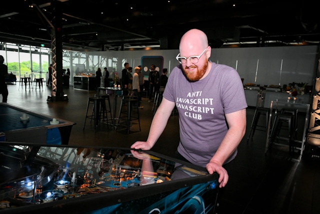 Astro core member, Nate playing the pinball machine.