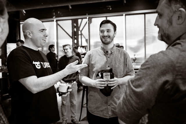 Black and white photo of Glauber, from Turso, speaking with Matthew, core contributor and framework lead at Astro, and an Astro core maintainer.