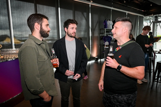 Guests talking and drinking with one another.