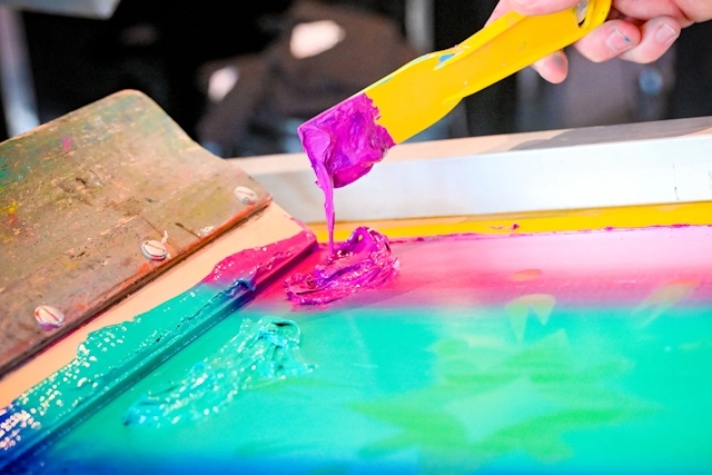 Closeup of the paint-like material used in a t-shirt printing press.