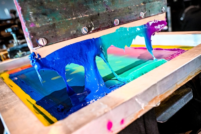 Closeup of the paint-like material used in a t-shirt printing press.