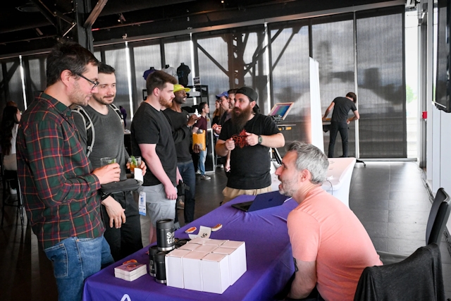 Sentry speaking to guests at their sponsor booth.