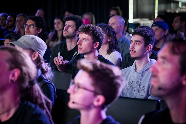 Audience members listening to the keynote speaker.