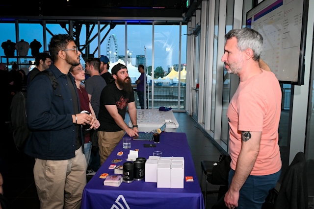 Guests listen intently as Sentry explains their product at their sponsor booth.