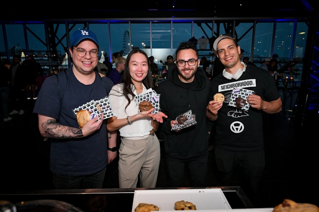 A group of guests pose with their gourmet cookies.