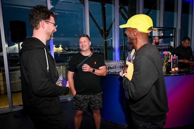 Guests chatting in front of the alcohol bar.